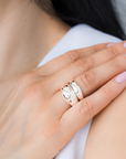 Close-up of a hand wearing two sterling silver rings; one is voluptuous and pairs perfectly with a smaller one, creating the perfect duo. / beblue bijoux