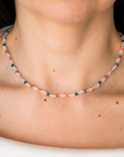 Necklace with multicolored beads worn by a person