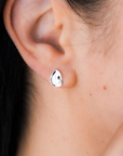 Close-up of an ear wearing a silver pebble earring