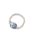 Silver elastic ring with a blue sodalite stone on a white background