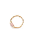 A gold-colored elastic ring with 3 bead of pink quartz in the center, from the Héritage Collection.