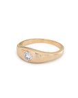 Gold ring with a zircon on a white background