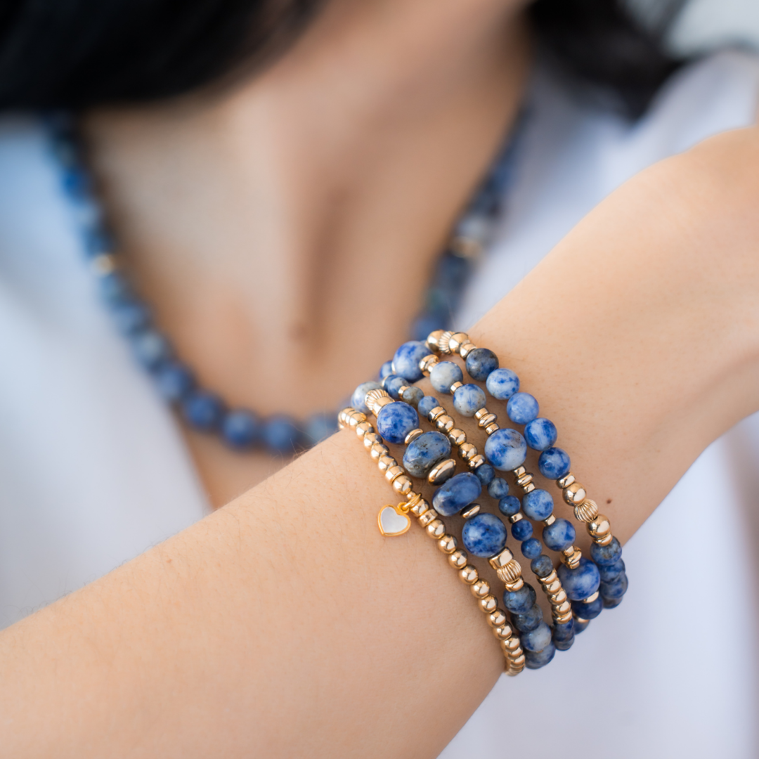 Stack of blue beaded bracelets in blue sodalite and 14kt gold vermeil, with a heart charm / Beblue Bijoux