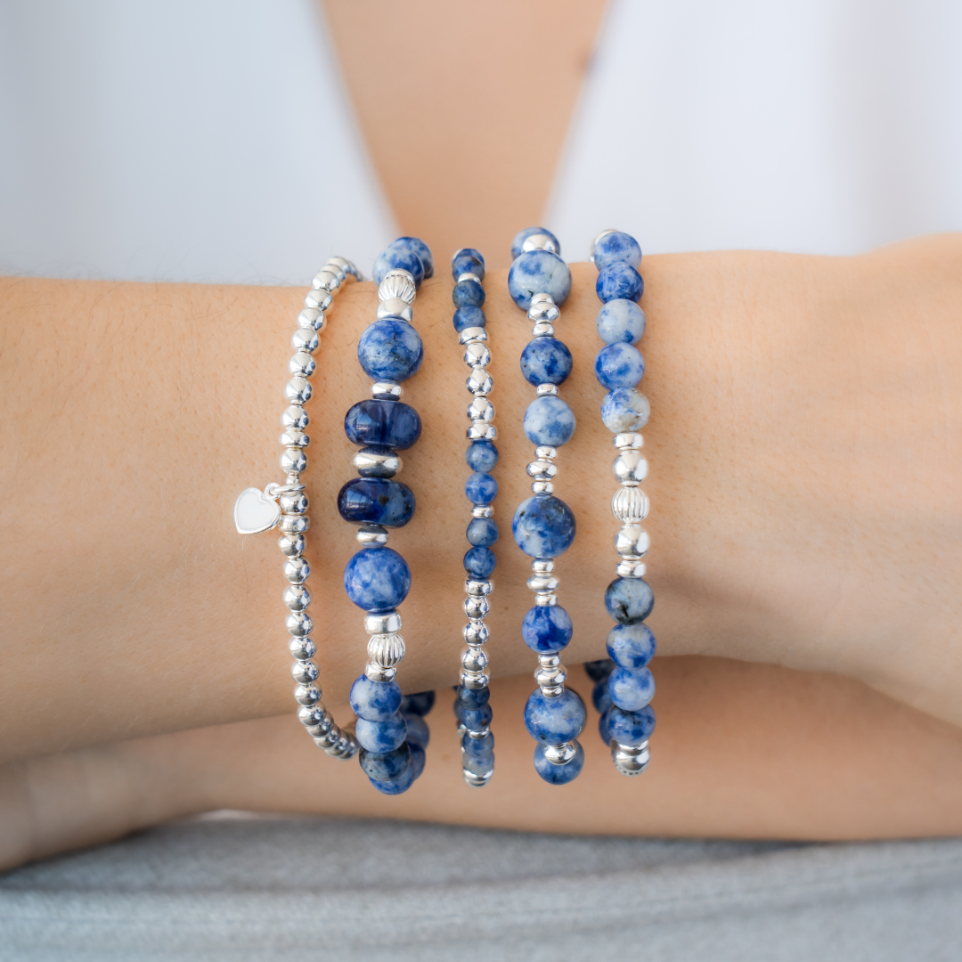 Stack of blue beaded bracelets in blue sodalite and sterling silver, with a heart charm / Beblue Bijoux