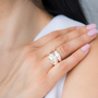 Close-up of a hand wearing two sterling silver rings; one is voluptuous and pairs perfectly with a smaller one, creating the perfect duo. / beblue bijoux