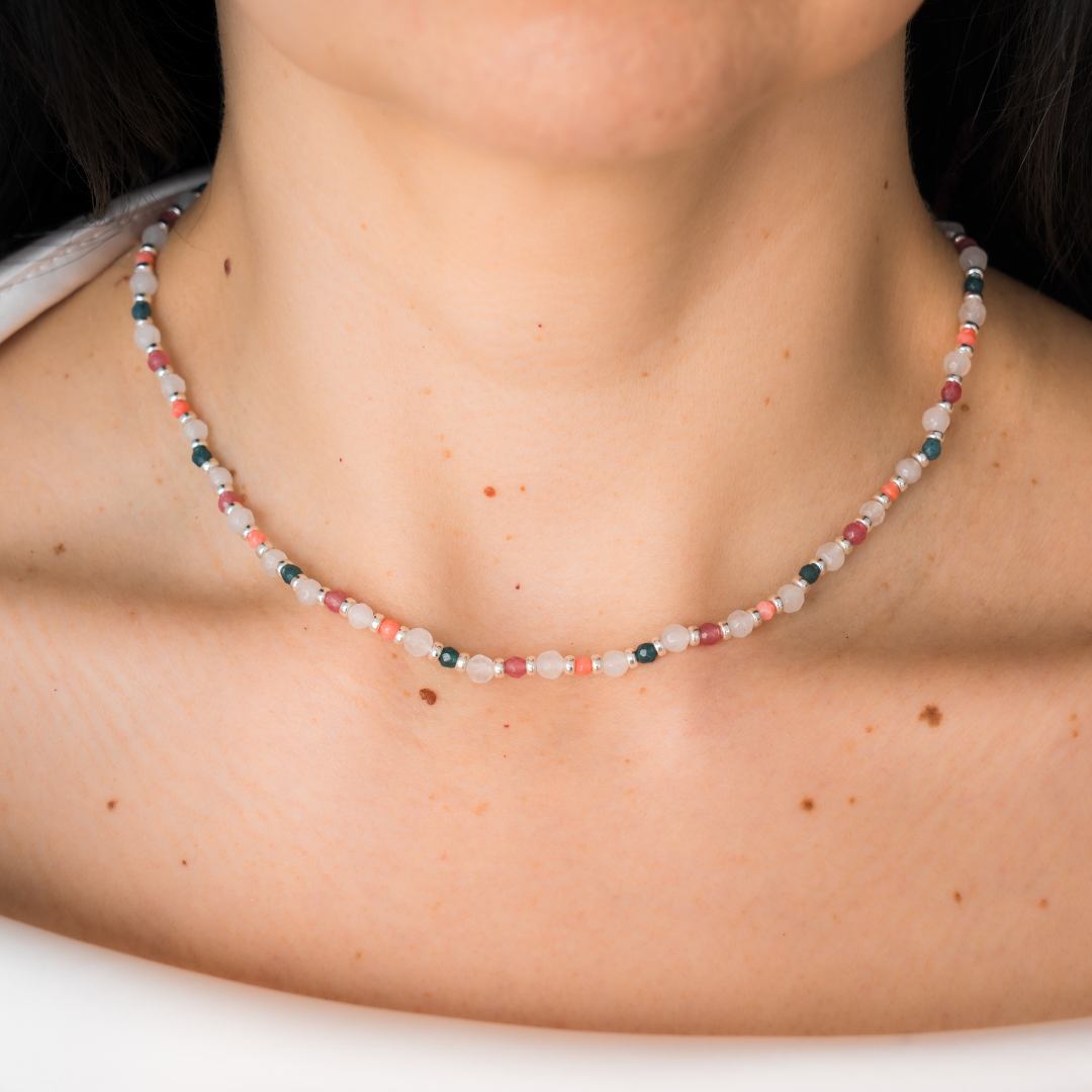 Necklace with multicolored beads worn by a person