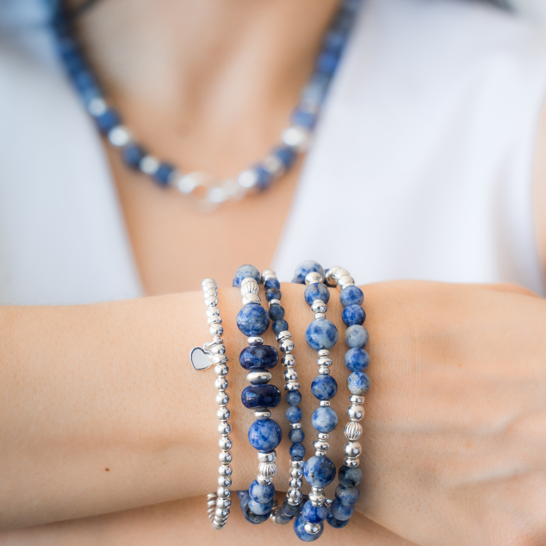 Stack of blue beaded bracelets in blue sodalite and sterling silver, with a heart charm / Beblue Bijoux