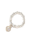 Pearl elastic ring with a central stone on a white background