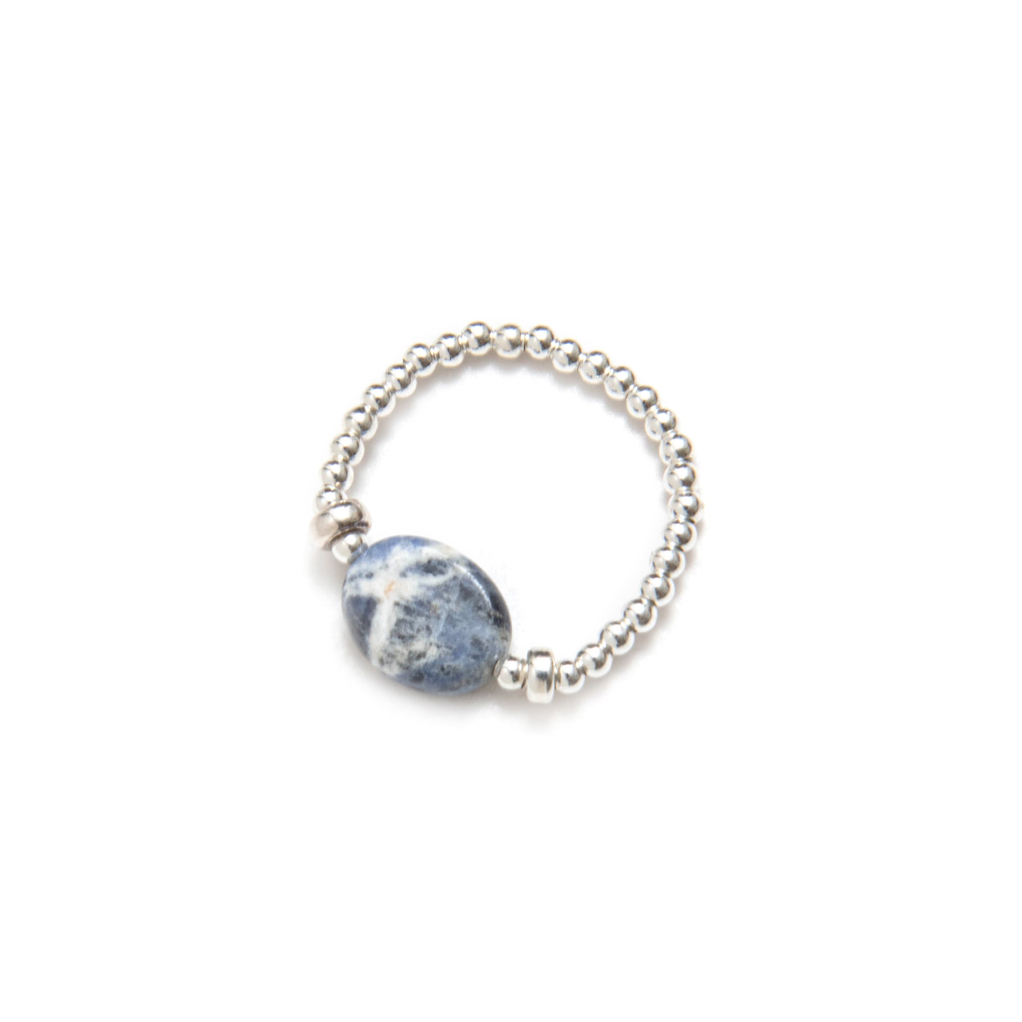Silver elastic ring with a blue sodalite stone on a white background