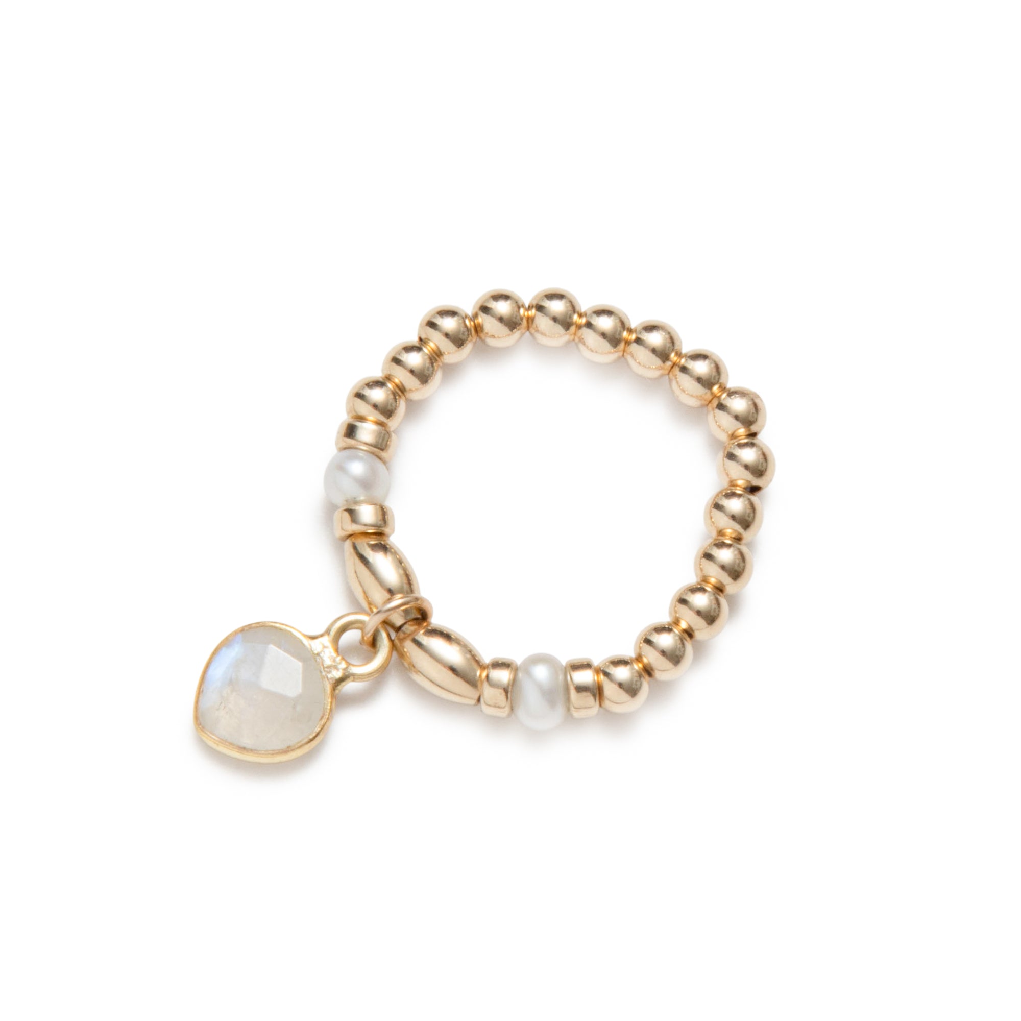 Gold elastic ring with pearls and a moonstone charm on a white background