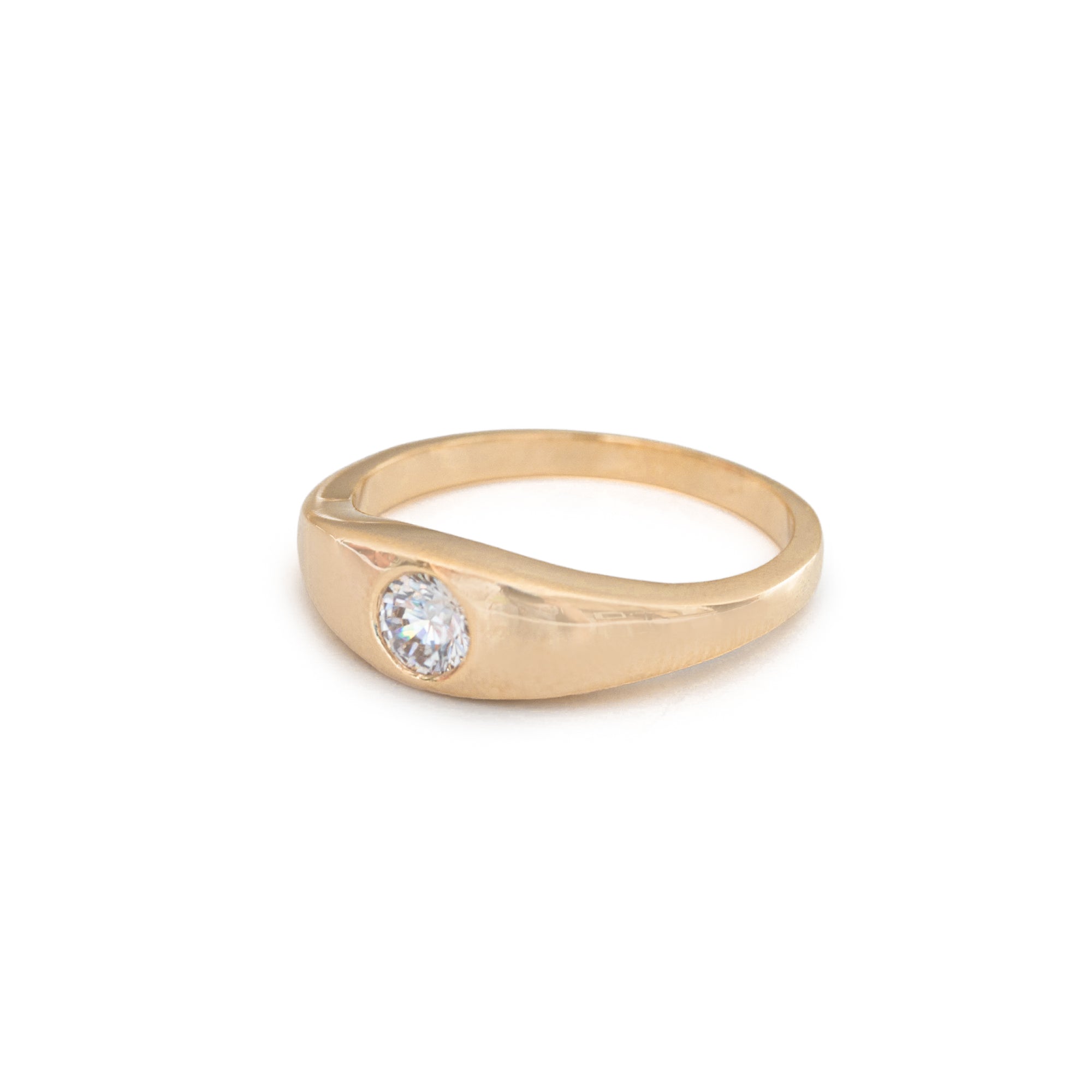 Gold ring with a zircon on a white background