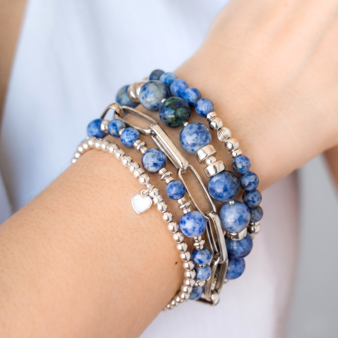 Stack of blue beaded bracelets in blue sodalite and silver with a heart charm / Beblue Bijoux