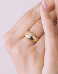 Close-up of a hand wearing two gold vermeil; one is voluptuous and pairs perfectly with a smaller one, creating the perfect duo. / beblue bijoux