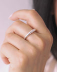 Close-up of a hand wearing a silver ring with a blurred background